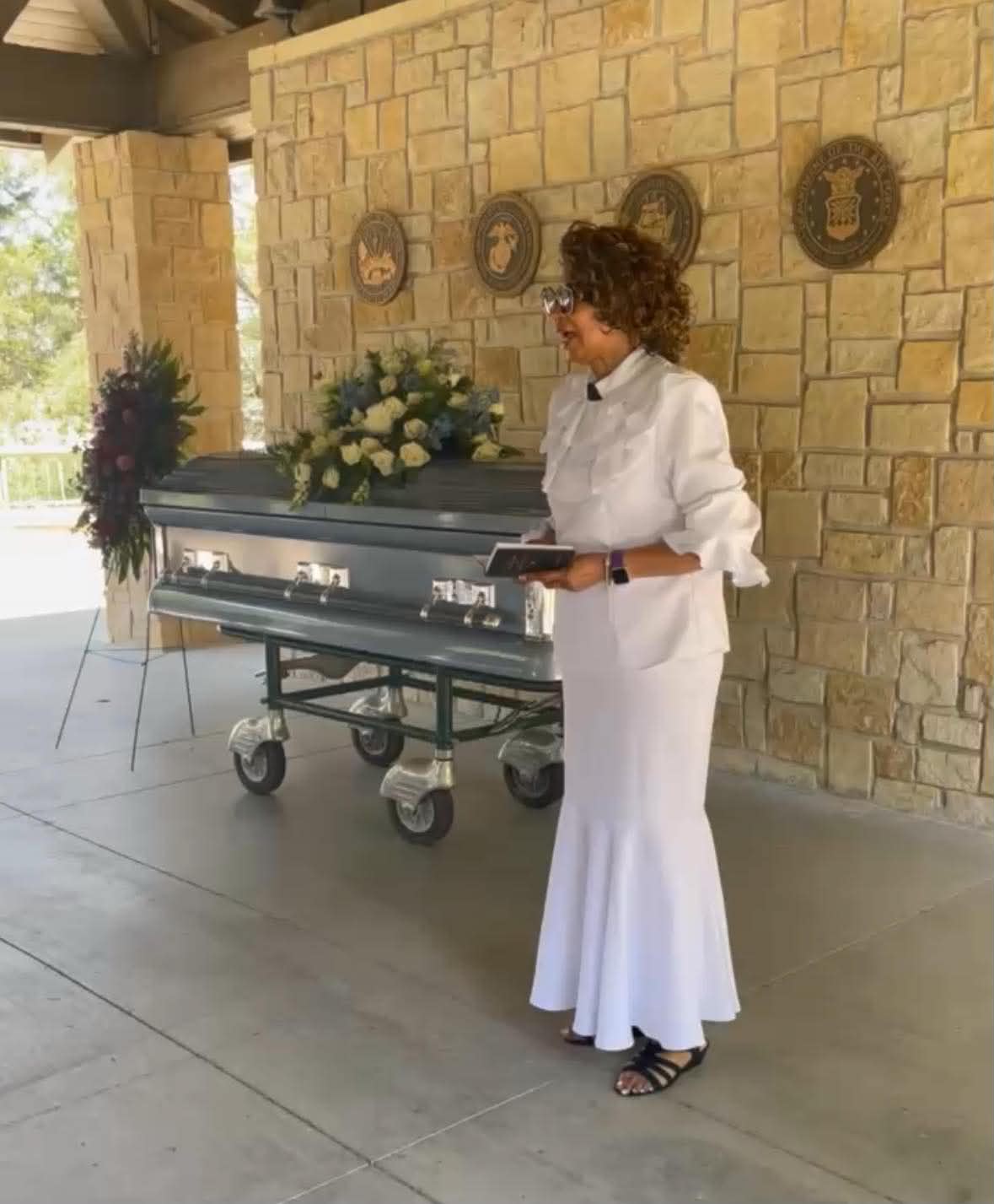 A coach standing near a memorial service.