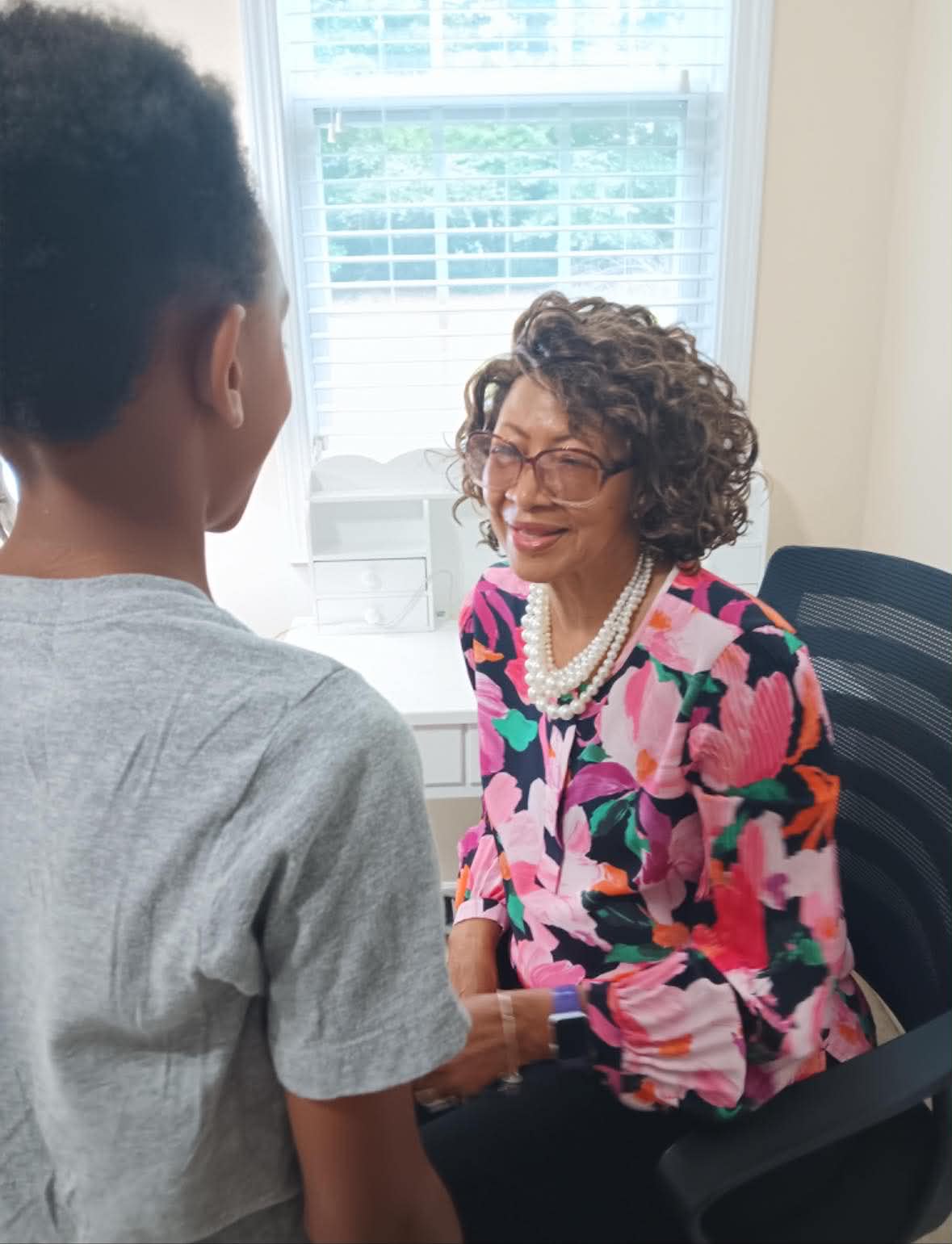 A coach speaking with a young person.