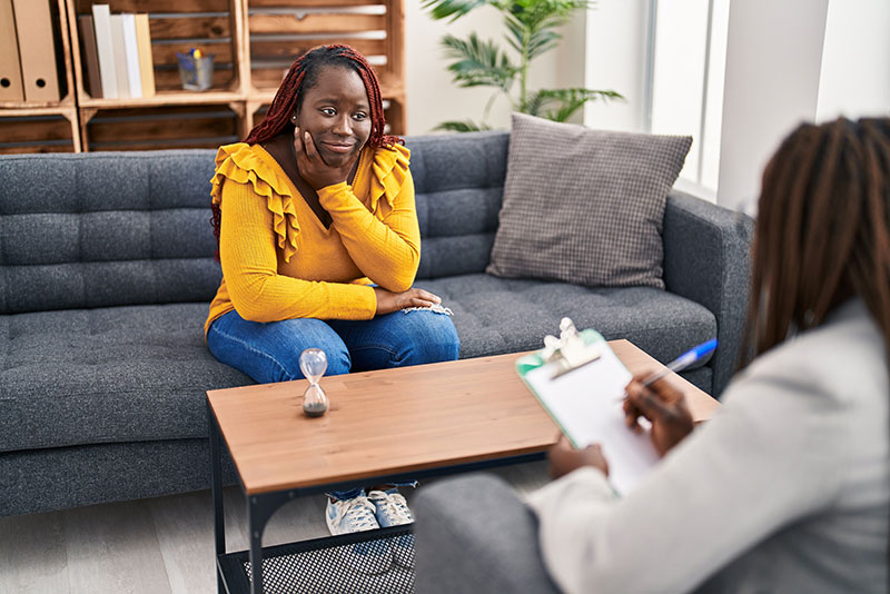 A person speaking with a counselor in a supportive session.